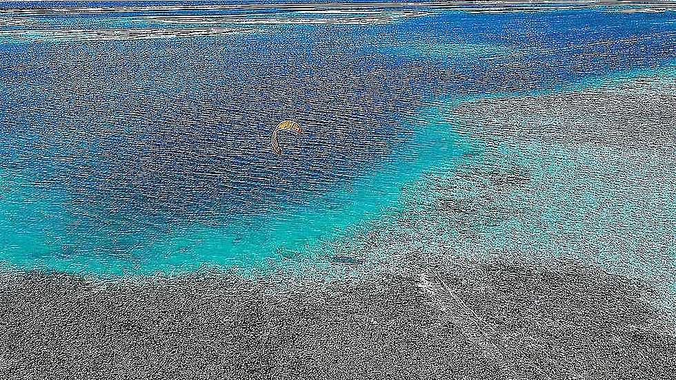 Kitesurfing over the turquoise Paje lagoon
